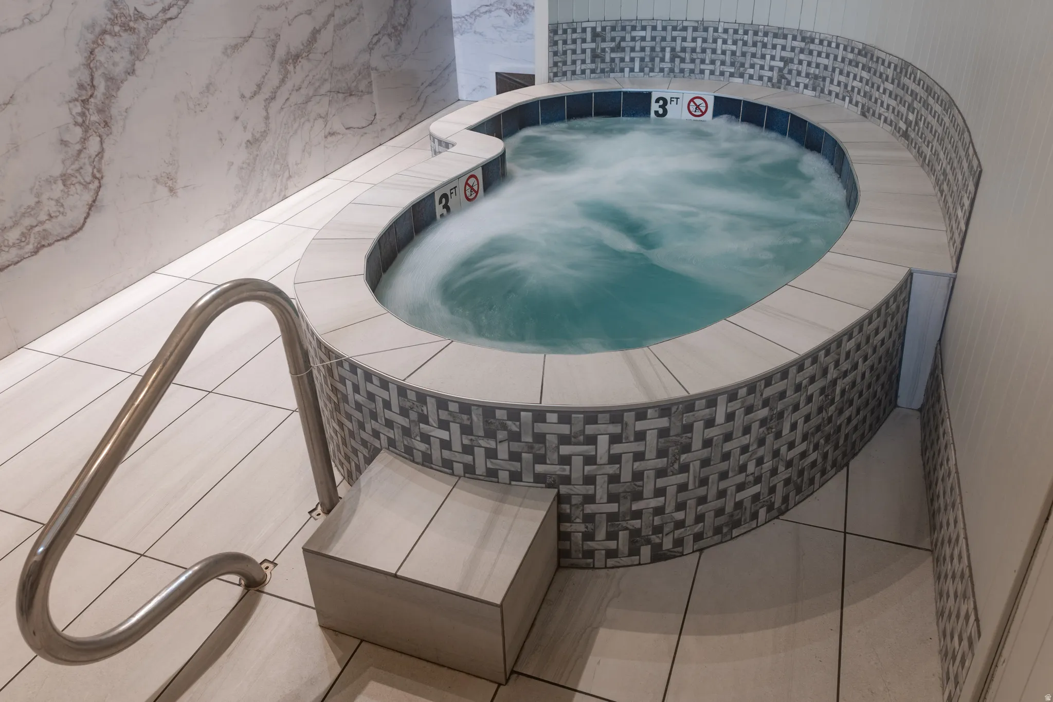 View of pool with a hot tub