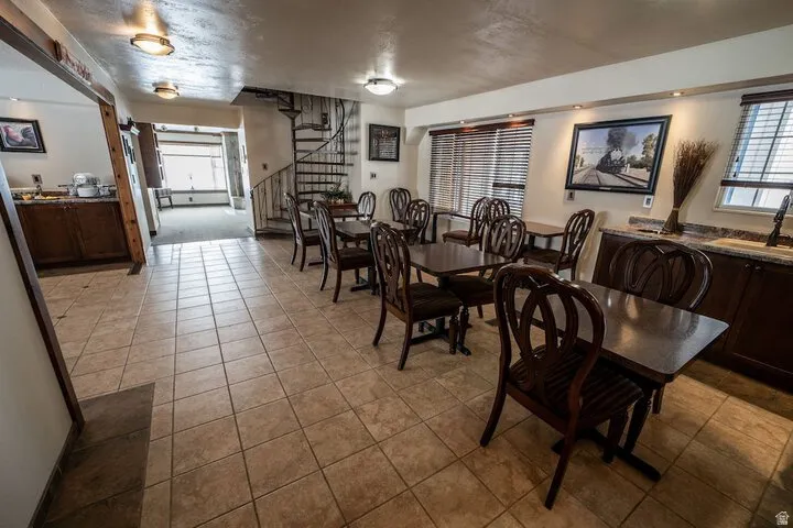 Dining space featuring stairway and light tile patterned floors