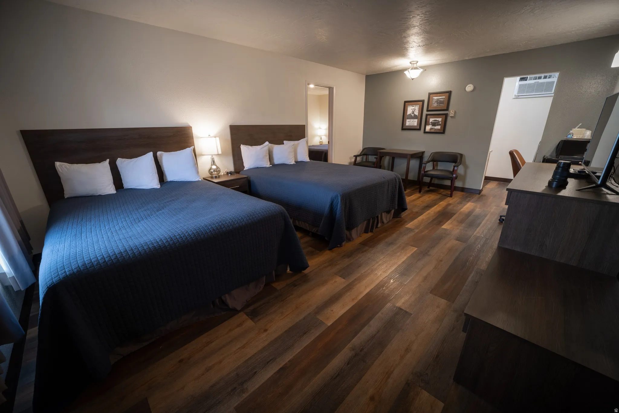 Bedroom featuring an office area, dark wood finished floors, and ensuite bath