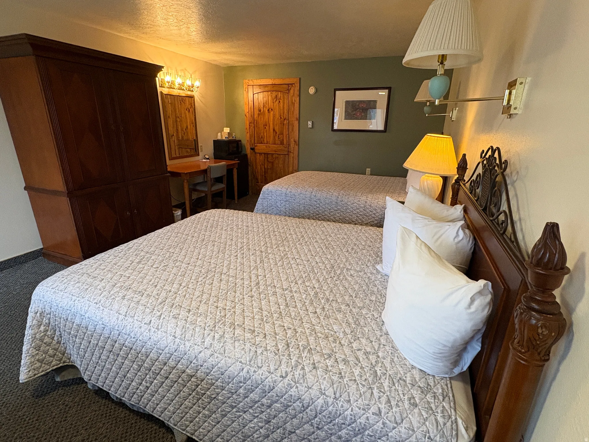 Carpeted bedroom with a textured ceiling and baseboards