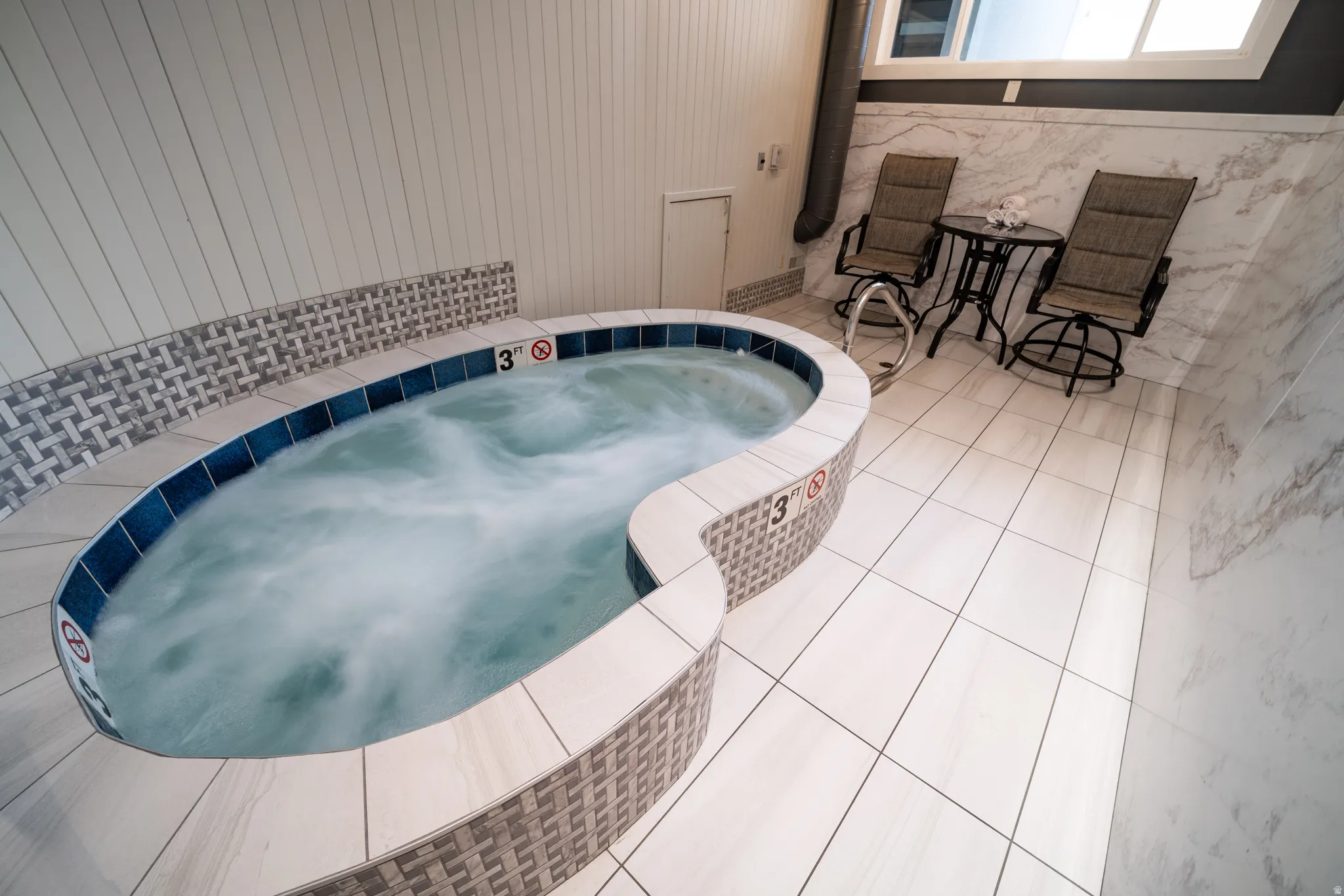 View of pool with an in-ground hot tub