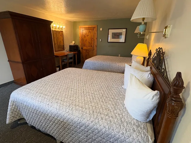 Carpeted bedroom with a textured ceiling and baseboards