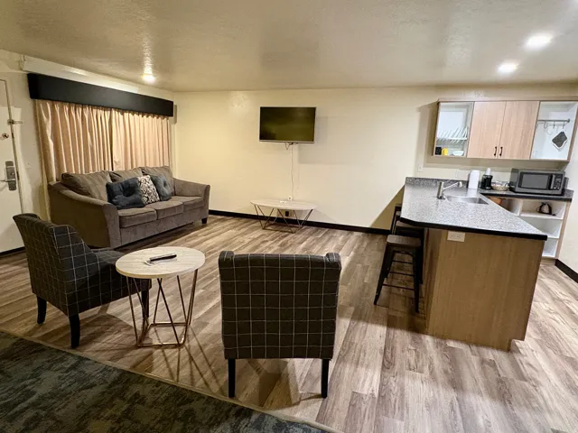 Living area with light wood-type flooring, a textured ceiling, and recessed lighting