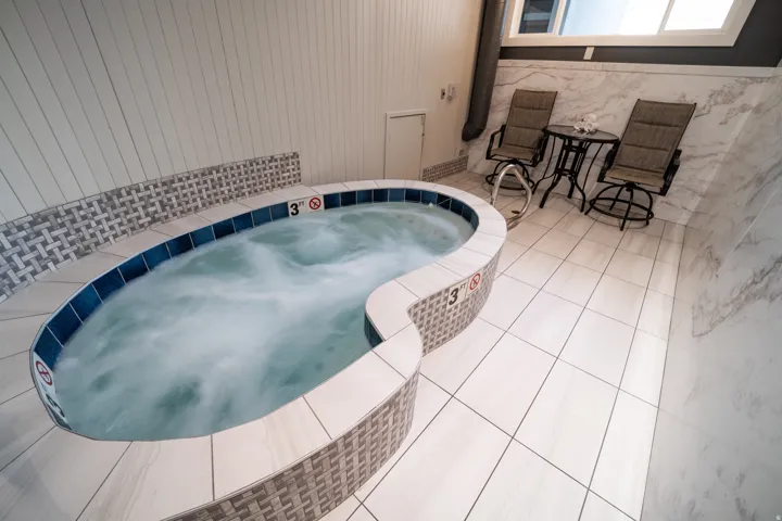 View of pool with an in-ground hot tub