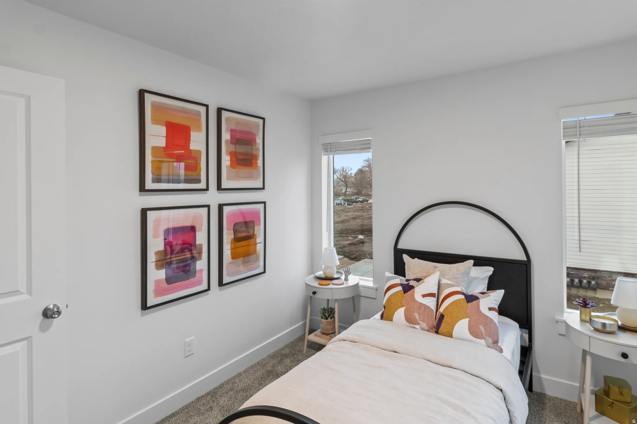 Bedroom with dark carpet and baseboards