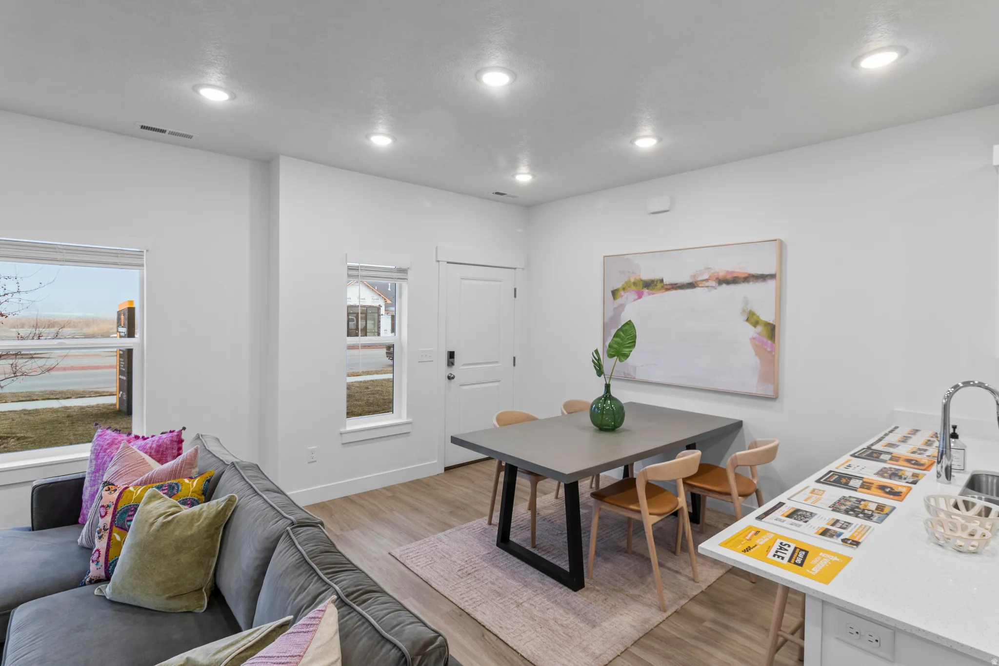 Dining room with light wood-style floors and recessed lighting