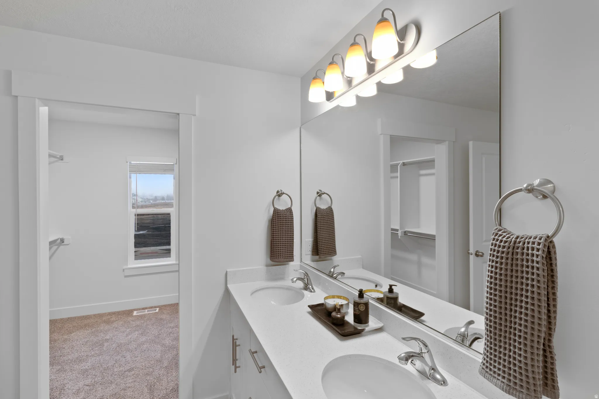 Full bathroom with double vanity and light colored carpet