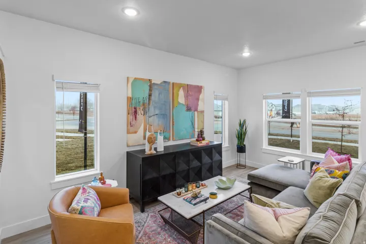 Living area featuring wood finished floors, healthy amount of natural light, and recessed lighting