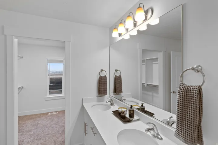 Full bathroom with double vanity and light colored carpet