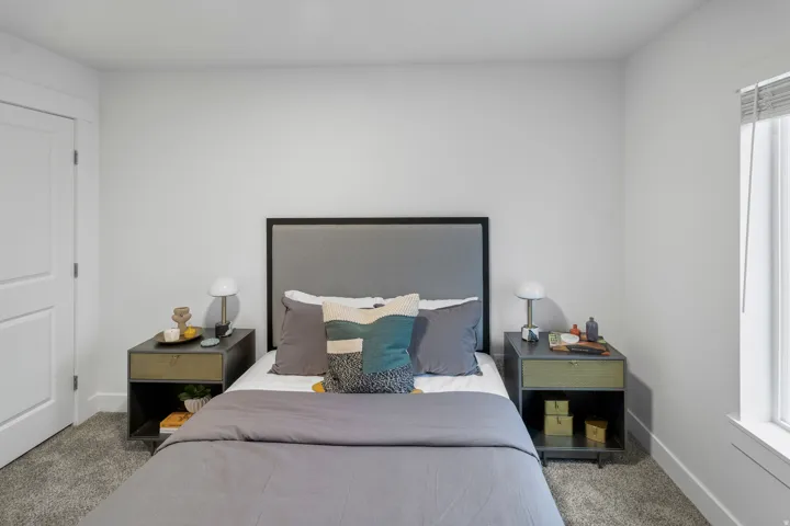 Carpeted bedroom featuring baseboards