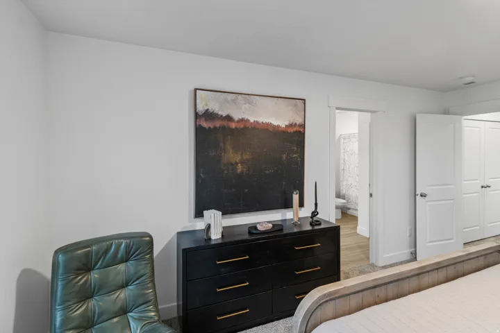 Bedroom featuring baseboards and ensuite bathroom