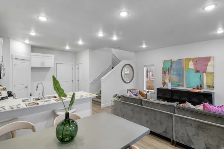 Living room with light wood-type flooring and recessed lighting