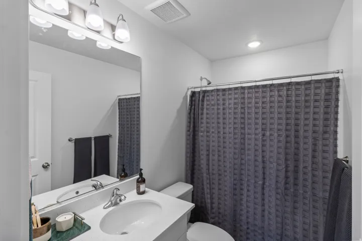 Full bathroom with vanity and a shower with shower curtain