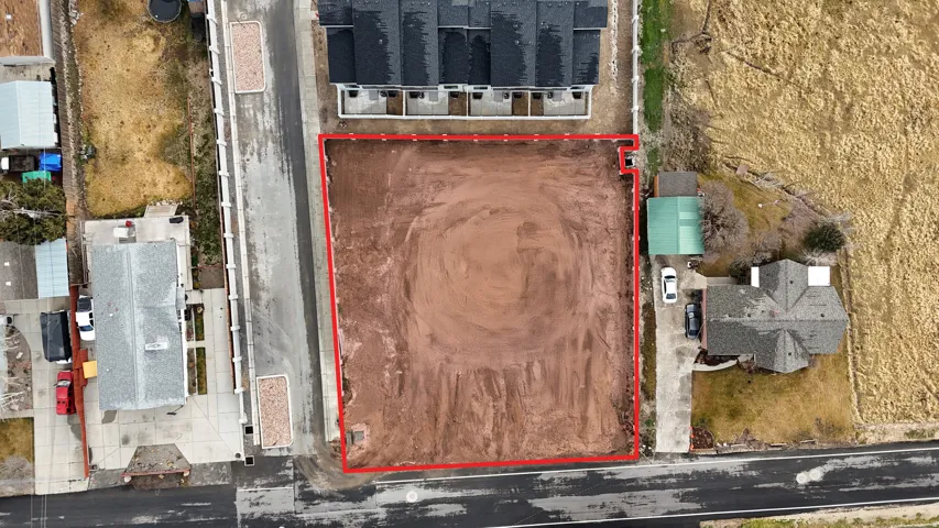 Aerial view of property and surrounding area featuring property parcel outlined