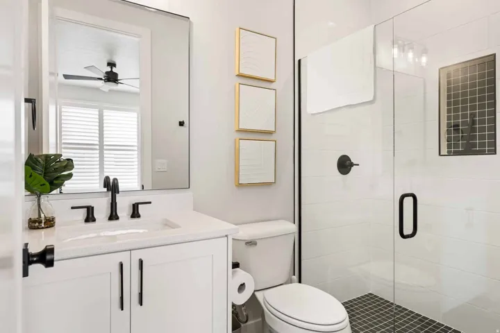 Full bath with a stall shower, vanity, and a ceiling fan