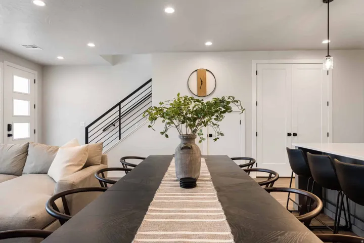 Dining space with recessed lighting and stairs