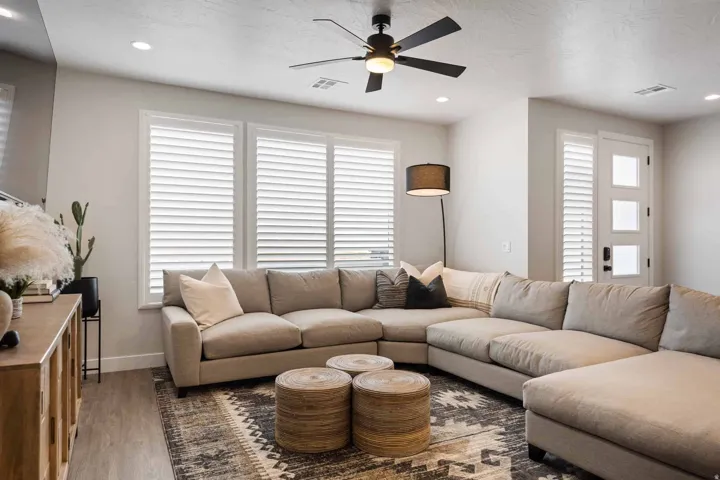 Living area featuring a ceiling fan, recessed lighting, and wood finished floors
