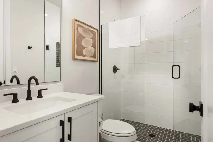 Bathroom featuring vanity and a stall shower