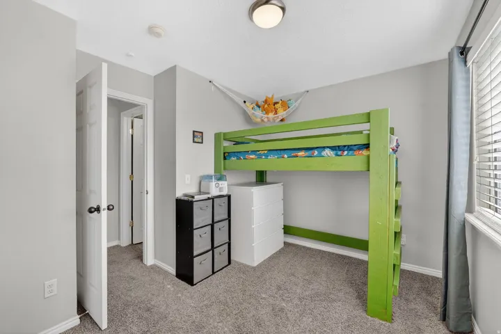 Bedroom featuring light colored carpet and baseboards