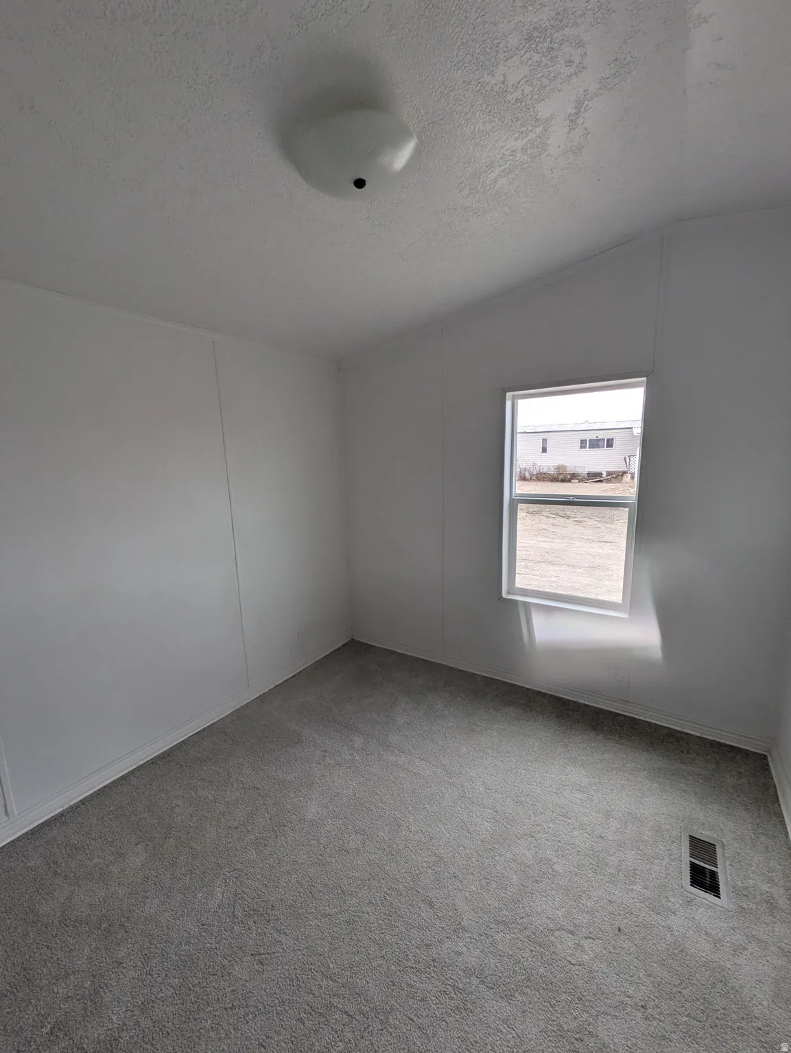 Spare room featuring carpet floors