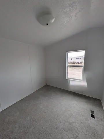 Spare room featuring carpet floors