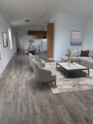 Living area featuring vaulted ceiling and dark wood-type flooring