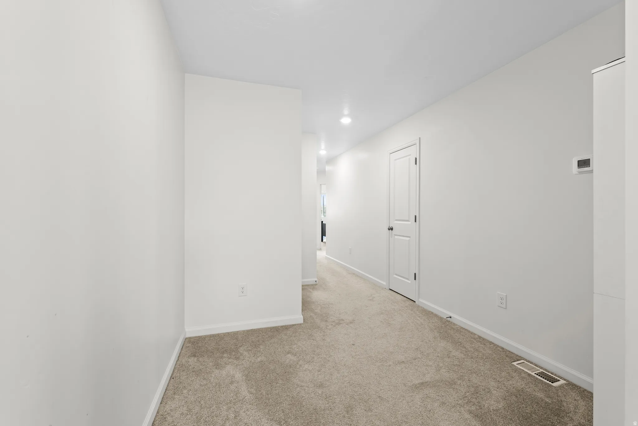 Empty room featuring baseboards and carpet floors