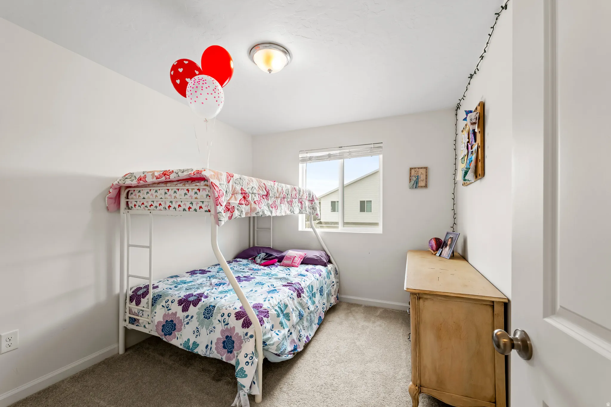 Bedroom with light carpet and baseboards