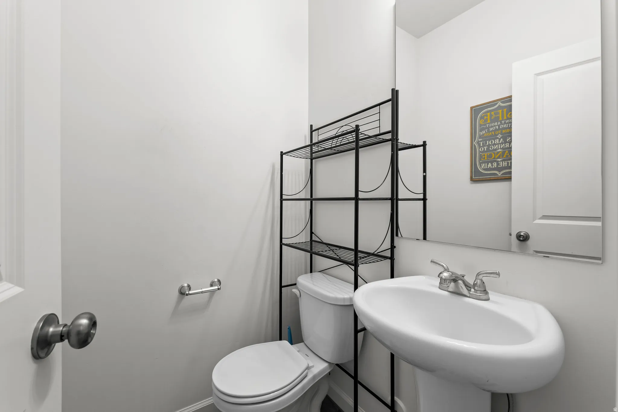 Half bath featuring toilet and a sink