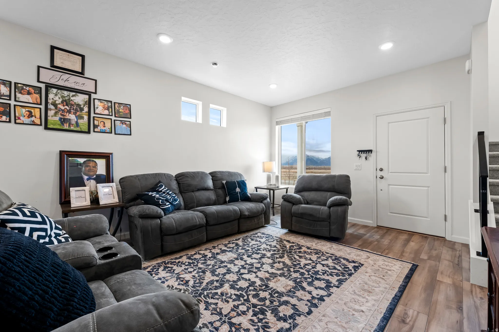 Living room with wood finished floors and recessed lighting