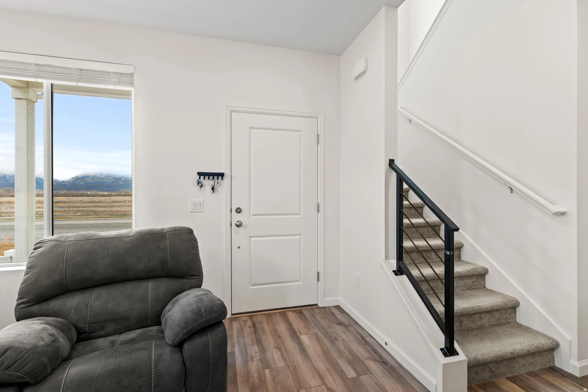 Entryway with stairs and wood finished floors