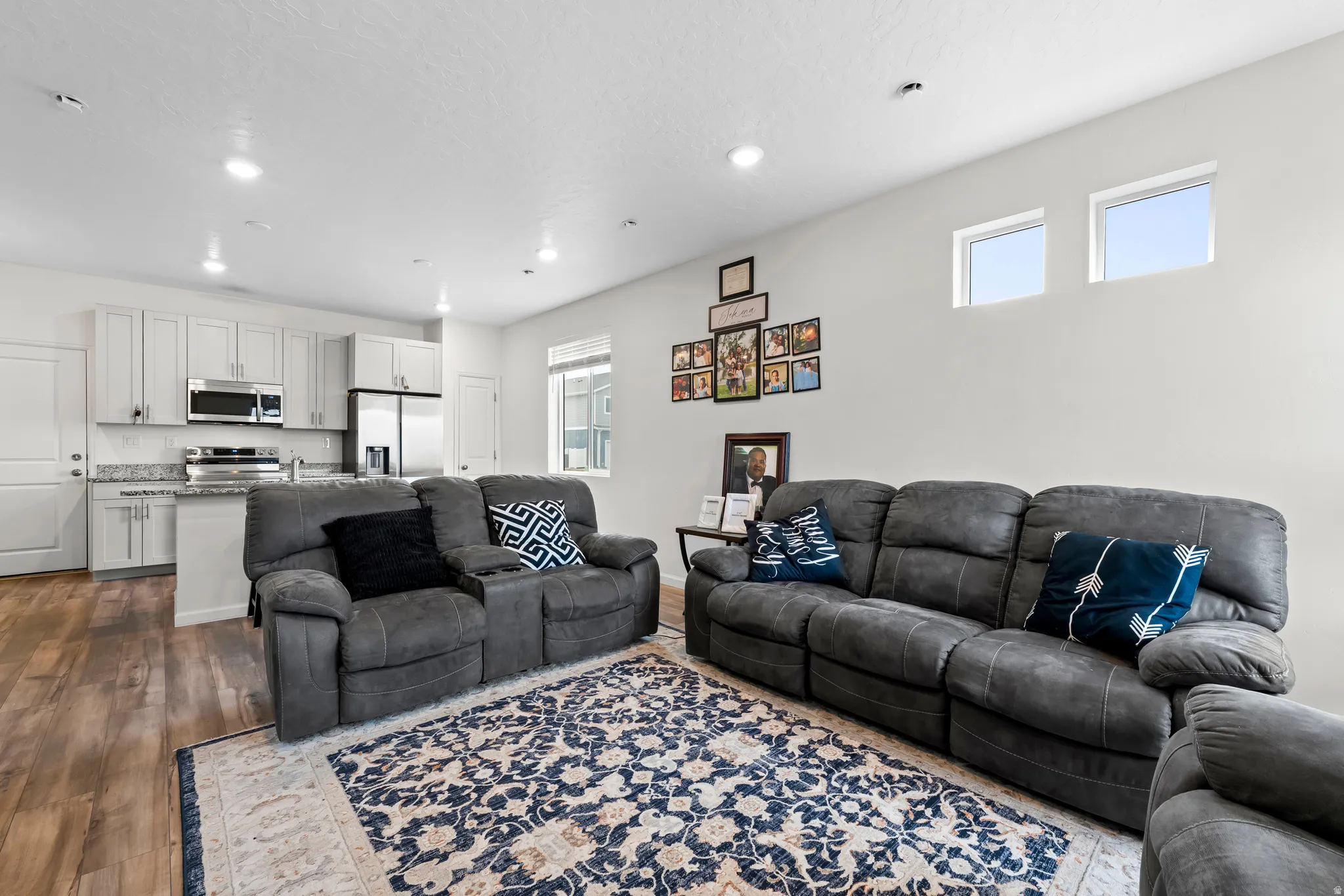 Living area with recessed lighting and dark wood-type flooring