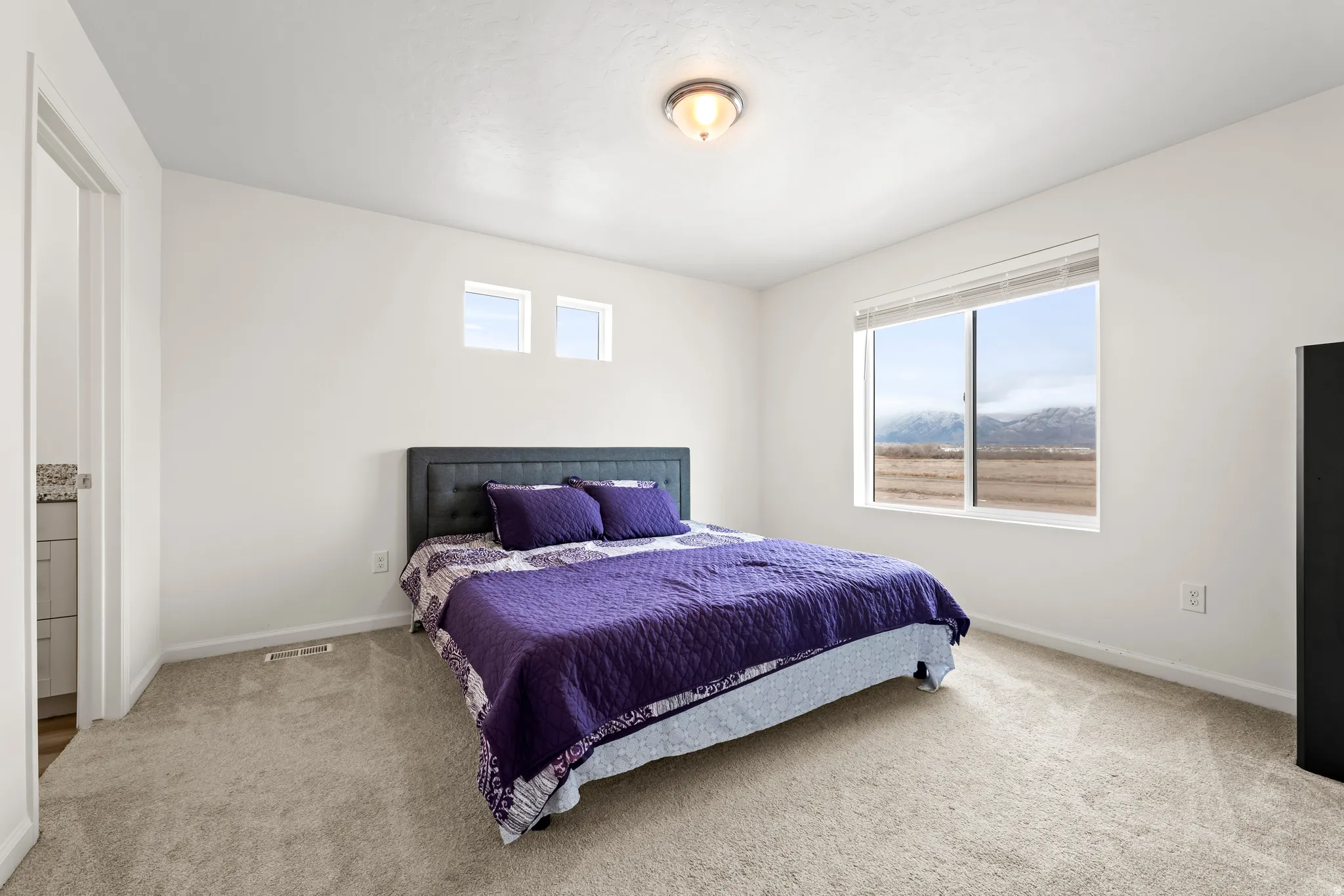Carpeted bedroom featuring baseboards