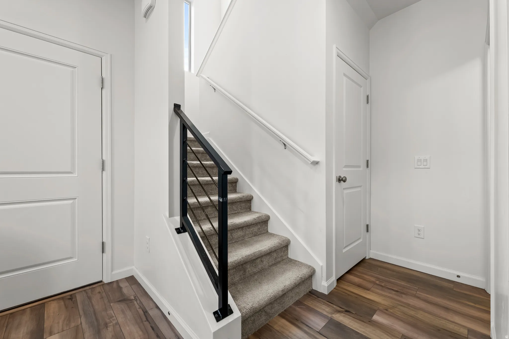 Staircase featuring wood finished floors