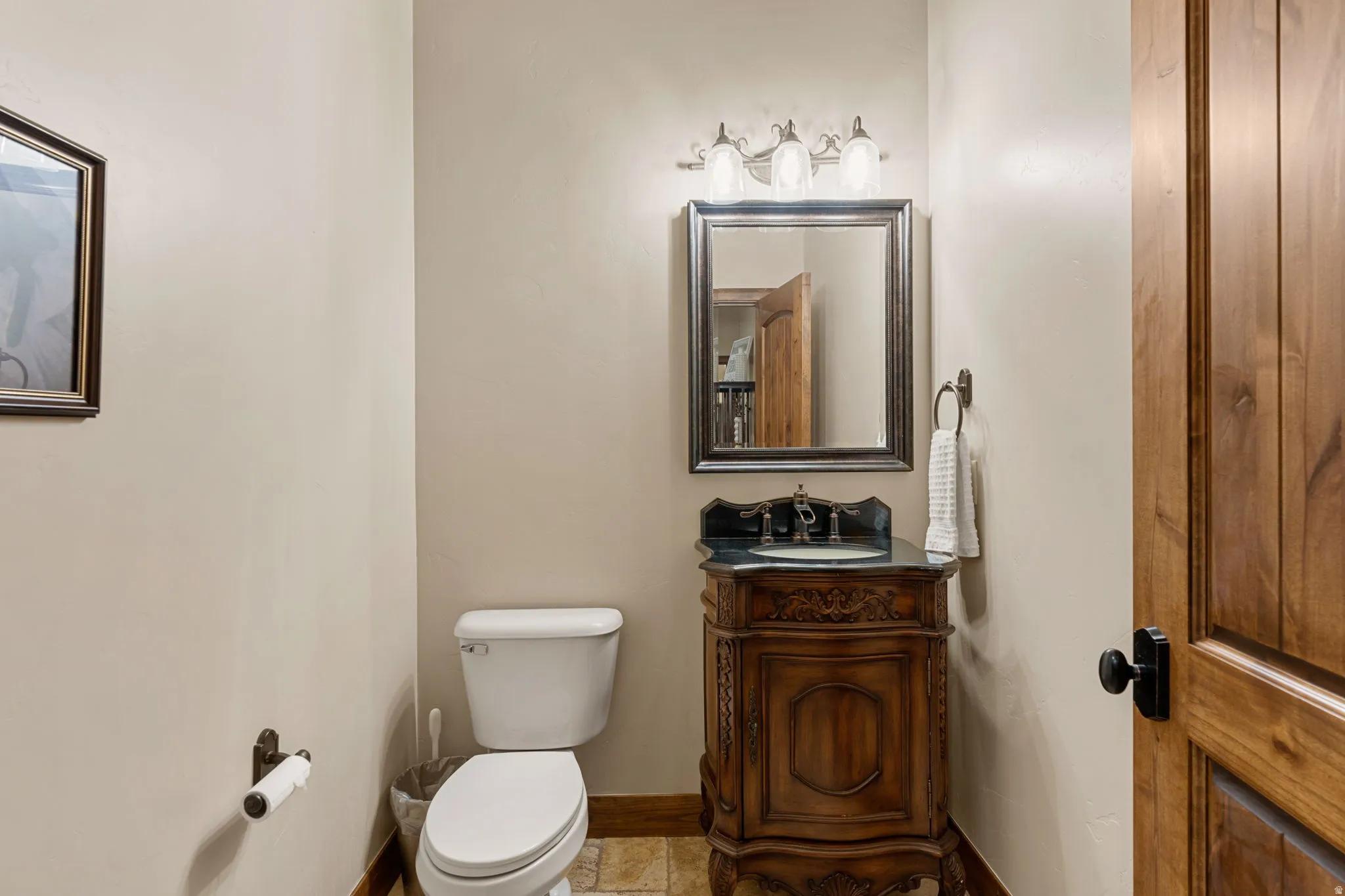 Half bath featuring vanity and toilet