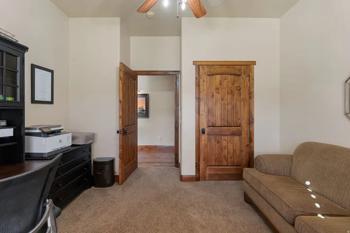Office featuring light colored carpet and a ceiling fan