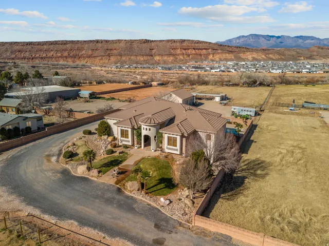 Aerial view of property and surrounding area with mountains