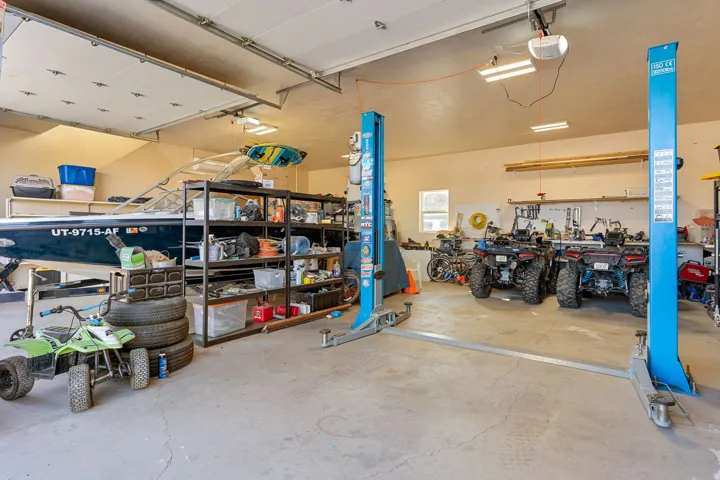 Garage featuring a workshop area and a garage door opener