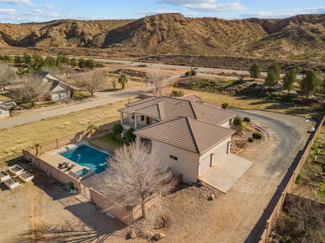 Aerial view of property and surrounding area with a mountain backdrop