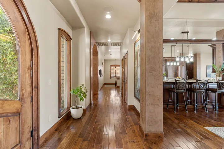 Corridor featuring dark wood finished floors and recessed lighting