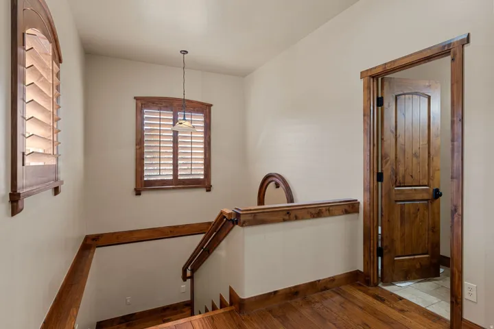 Hall featuring wood-type flooring and an upstairs landing