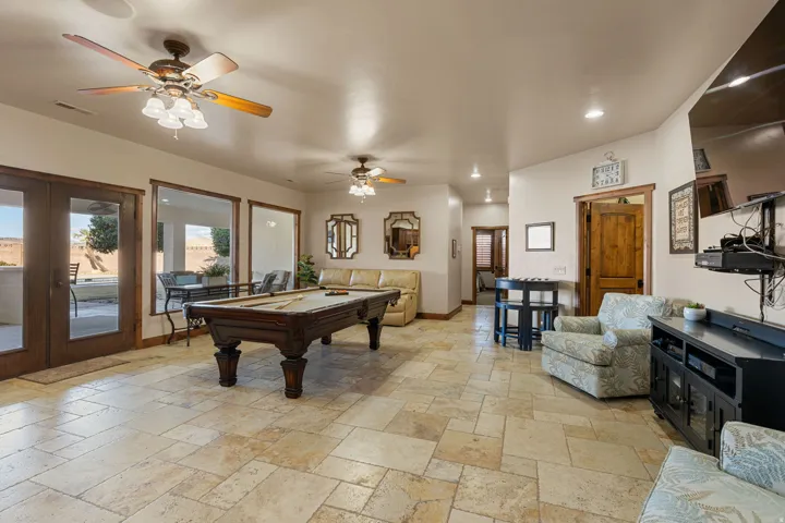 Game room with pool table, stone tile floors, ceiling fan, french doors, and recessed lighting