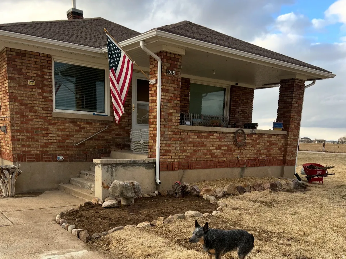 Single story home featuring brick siding and a shingled roof