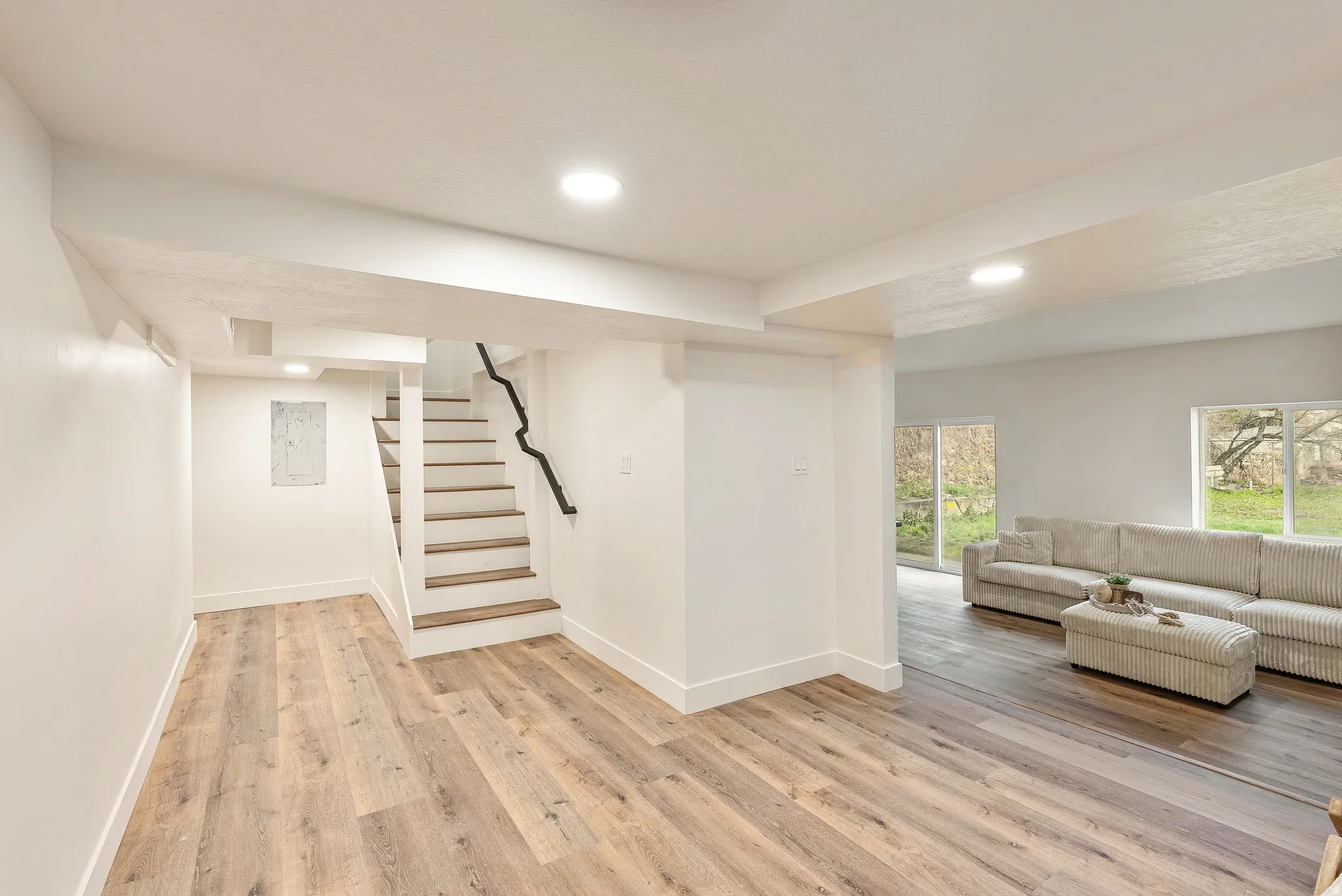 Living area featuring light wood finished floors and recessed lighting
