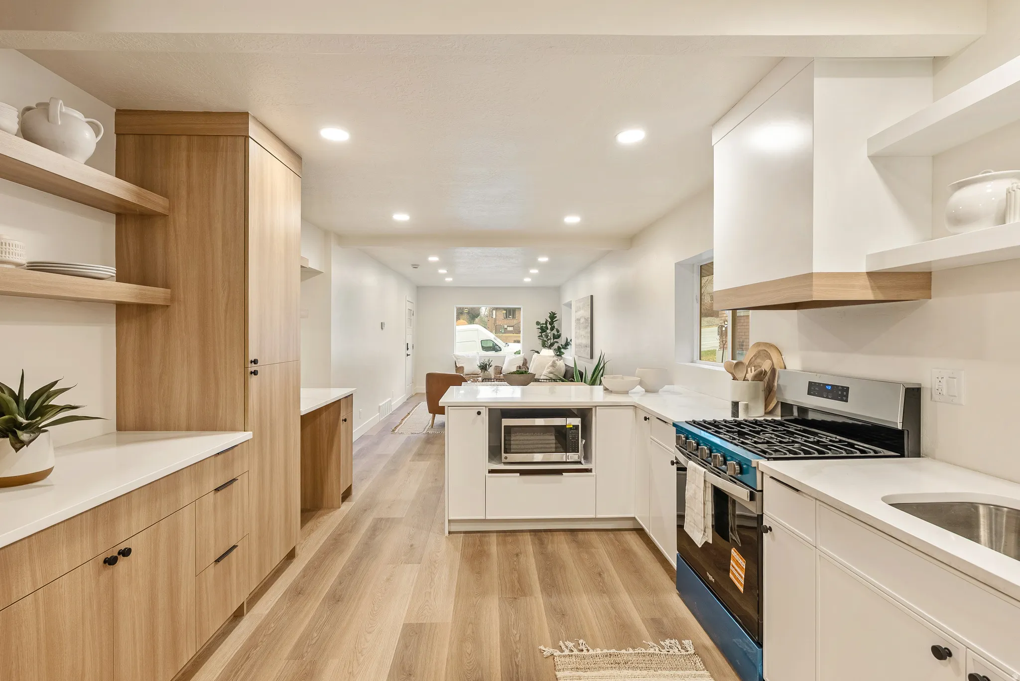 Kitchen with open shelves, stainless steel appliances, dual tone cabinetry, modern cabinets, and recessed lighting
