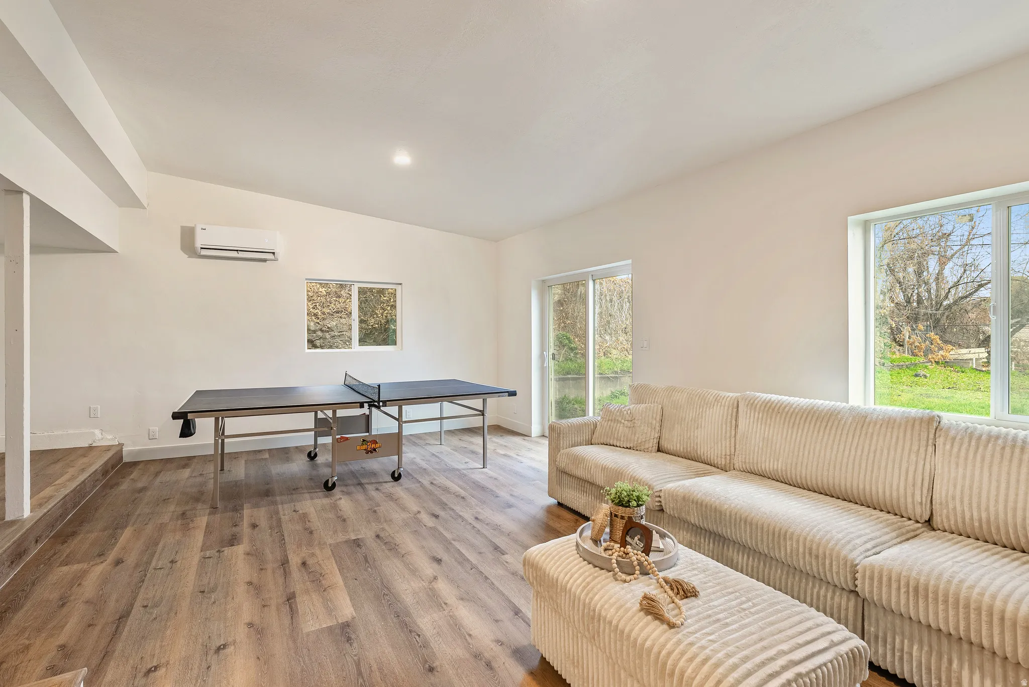 Living area featuring lofted ceiling, wood finished floors, and recessed lighting
