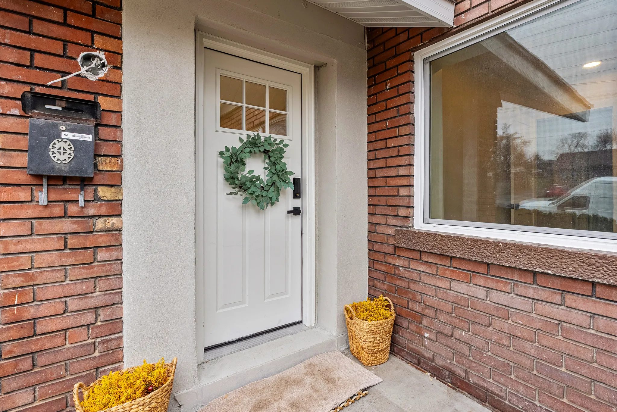 Entrance to property featuring brick siding
