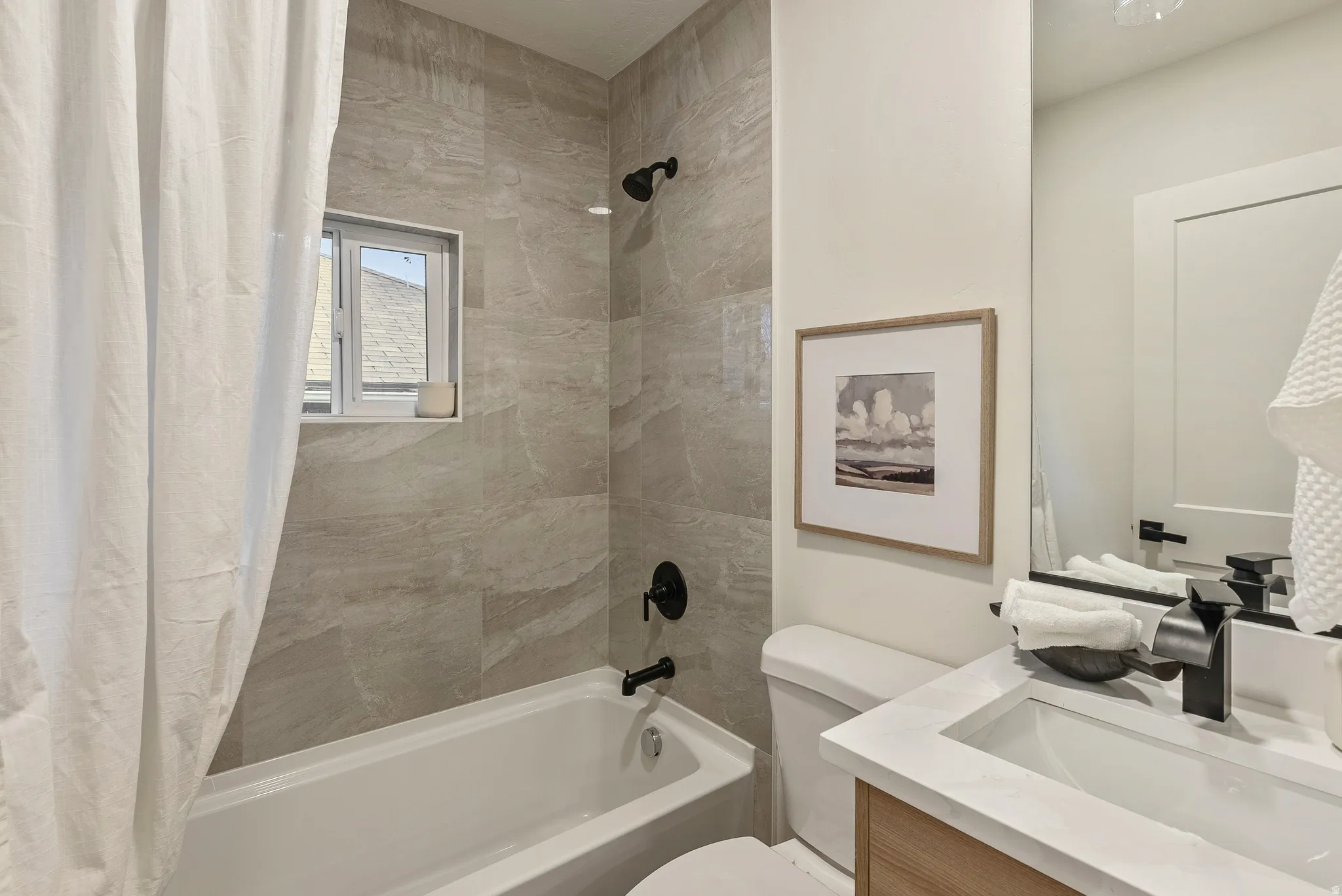 Bathroom featuring shower / bath combination with curtain and vanity