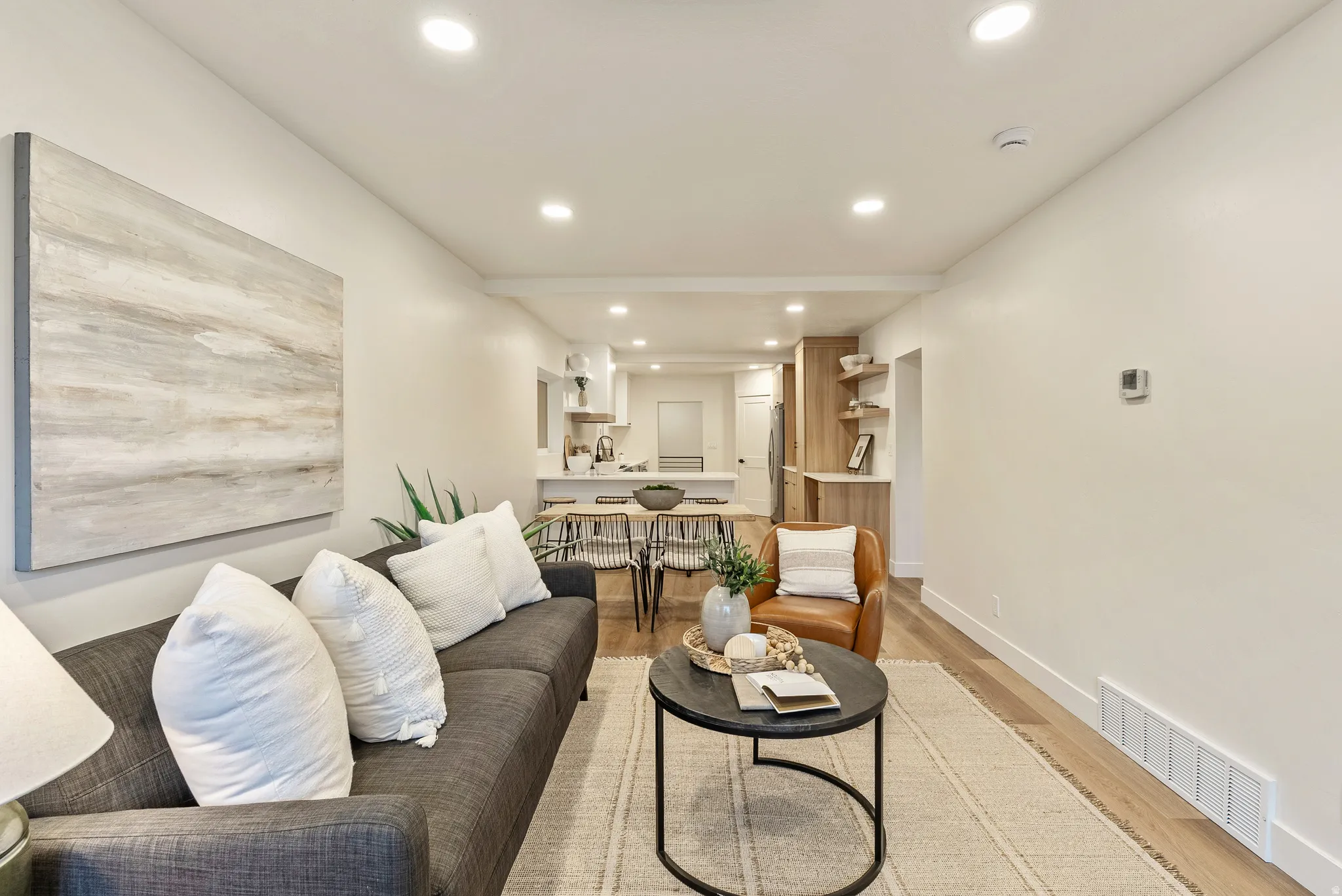 Living area with recessed lighting and light wood-style floors