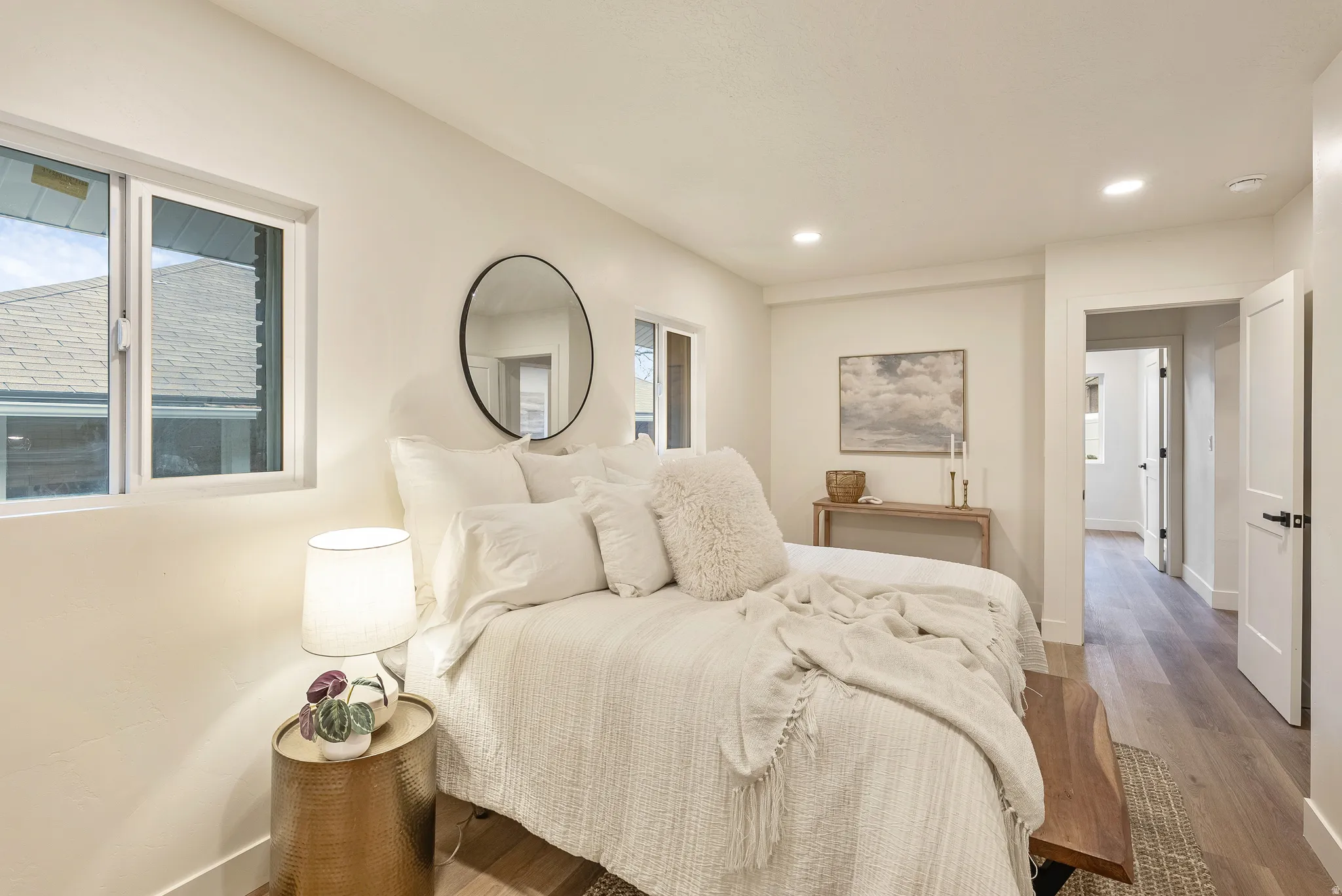Bedroom with wood finished floors, recessed lighting, and multiple windows